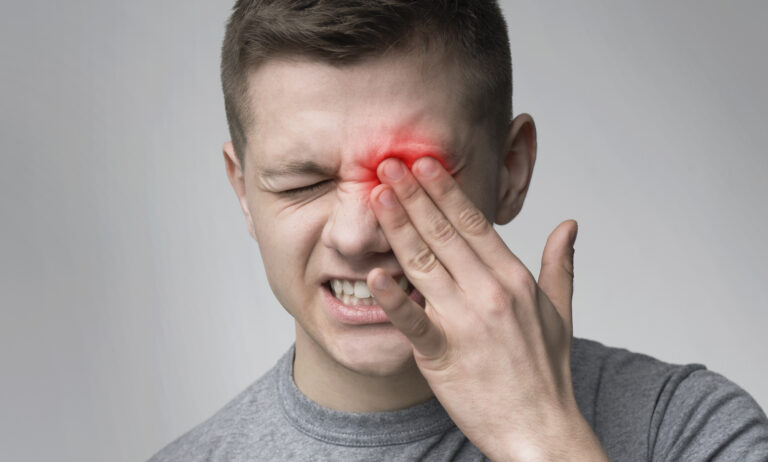 Upset man suffering from strong eye pain. Healthcare concept, panorama